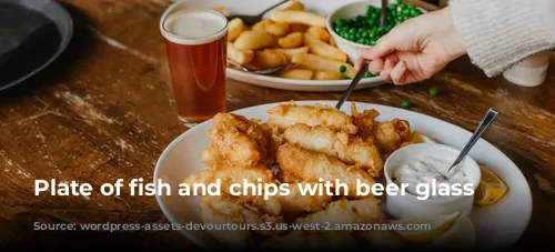 Plate of fish and chips with beer glass