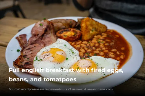 Full english breakfast with fired eggs, bacon, beans, and tomatpoes