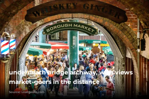 underneath bridge archway, with views on market-goers in the distance