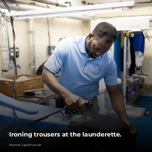 Ironing trousers at the launderette.