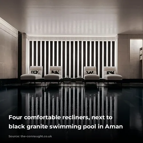 Four comfortable recliners, next to the black granite swimming pool in Aman Spa.