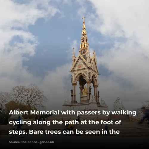 Albert Memorial with passers by walking and cycling along the path at the foot of the steps. Bare trees can be seen in the backgroud.