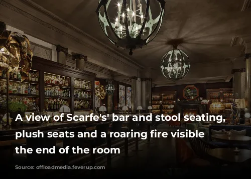 A view of Scarfe's' bar and stool seating, with plush seats and a roaring fire visible at the end of the room