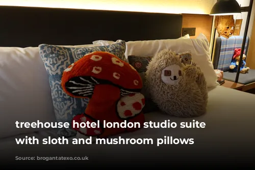 treehouse hotel london studio suite bed with sloth and mushroom pillows