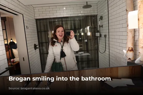 Brogan smiling into the bathroom mirror