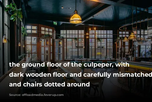 the ground floor of the culpeper, with a dark wooden floor and carefully mismatched tables and chairs dotted around