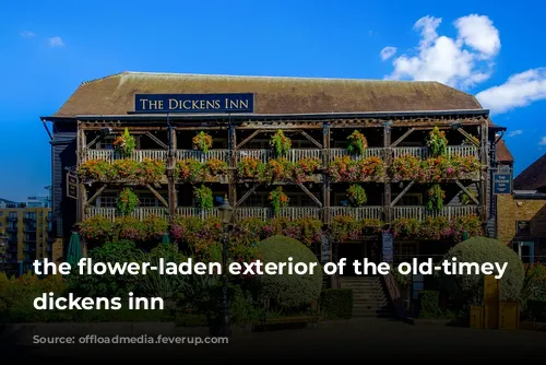 the flower-laden exterior of the old-timey looking dickens inn 