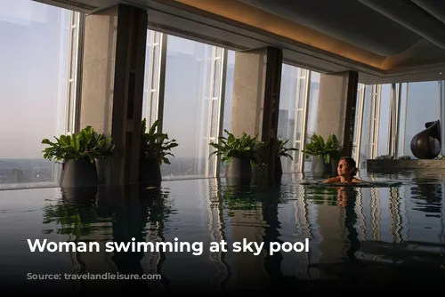 Woman swimming at sky pool