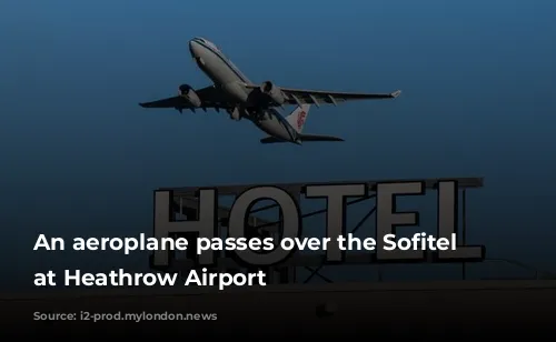 An aeroplane passes over the Sofitel hotel at Heathrow Airport