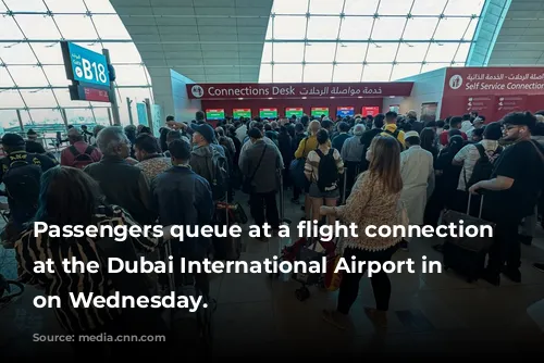 Passengers queue at a flight connection desk at the Dubai International Airport in Dubai on Wednesday.