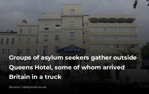 Groups of asylum seekers gather outside the Queens Hotel, some of whom arrived in Britain in a truck 