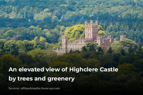 An elevated view of Highclere Castle surrounded by trees and greenery