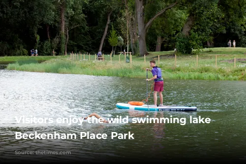 Visitors enjoy the wild swimming lake in Beckenham Place Park