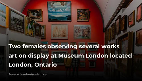 Two females observing several works of art on display at Museum London located in London, Ontario