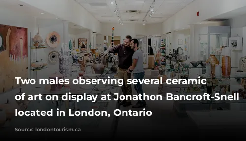 Two males observing several ceramic works of art on display at Jonathon Bancroft-Snell Gallery located in London, Ontario