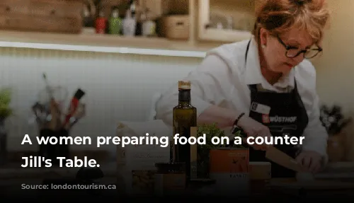 A women preparing food on a counter in Jill's Table.