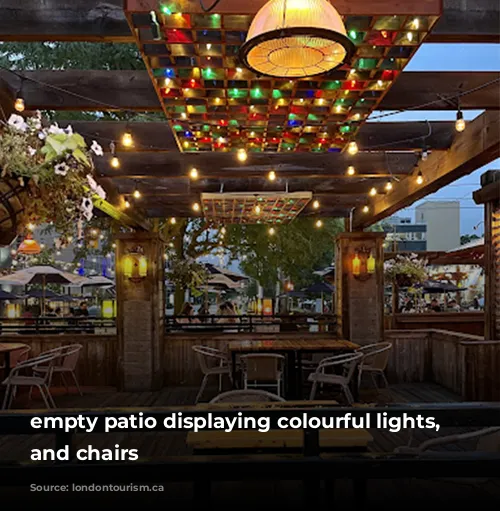 empty patio displaying colourful lights, tables and chairs