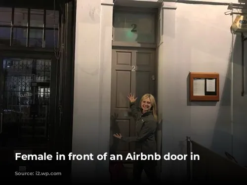 Female in front of an Airbnb door in London. 