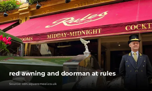 red awning and doorman at rules