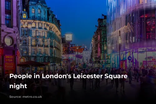 People in London's Leicester Square at night