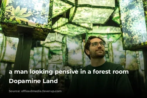 a man looking pensive in a forest room at Dopamine Land