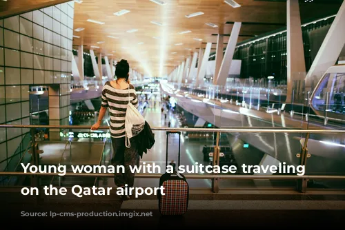 Young woman with a suitcase traveling solo on the Qatar airport