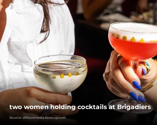 two women holding cocktails at Brigadiers