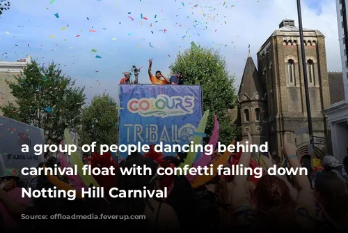 a group of people dancing behind a carnival float with confetti falling down at Notting Hill Carnival