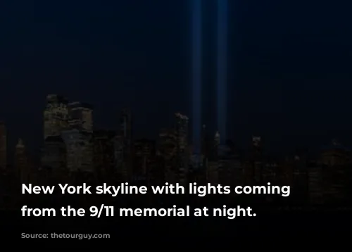 New York skyline with lights coming up from the 9/11 memorial at night.