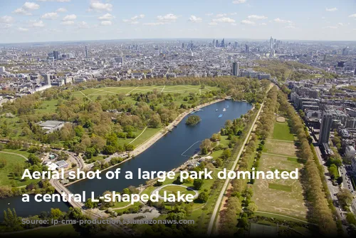 Aerial shot of a large park dominated by a central L-shaped lake