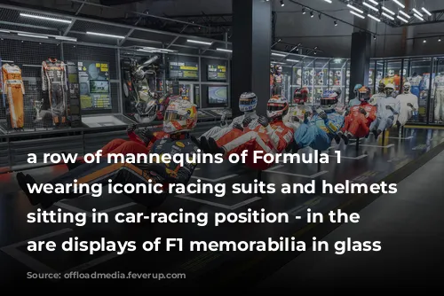 a row of mannequins of Formula 1 drivers wearing iconic racing suits and helmets and sitting in car-racing position - in the background are displays of F1 memorabilia in glass cases