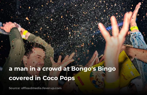 a man in a crowd at Bongo's Bingo getting covered in Coco Pops