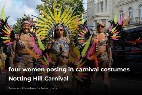 four women posing in carnival costumes at Notting Hill Carnival