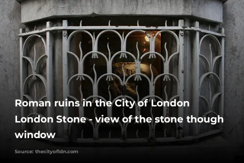 Roman ruins in the City of London - London Stone - view of the stone though a window 