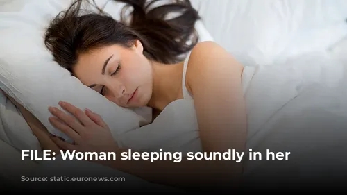 FILE: Woman sleeping soundly in her bed